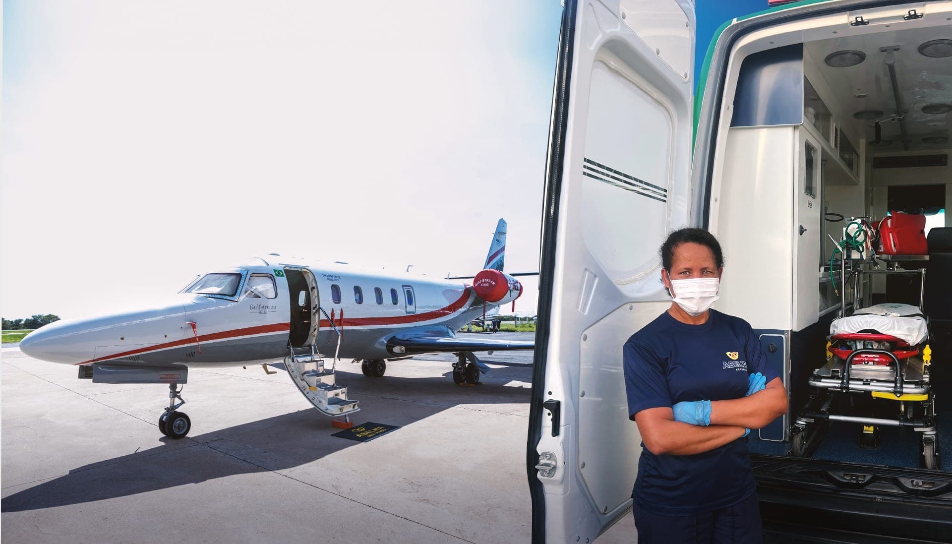 Enfermeira conduzindo maca até o jato Gulfstream G100 da Abelha, ao lado de uma ambulância